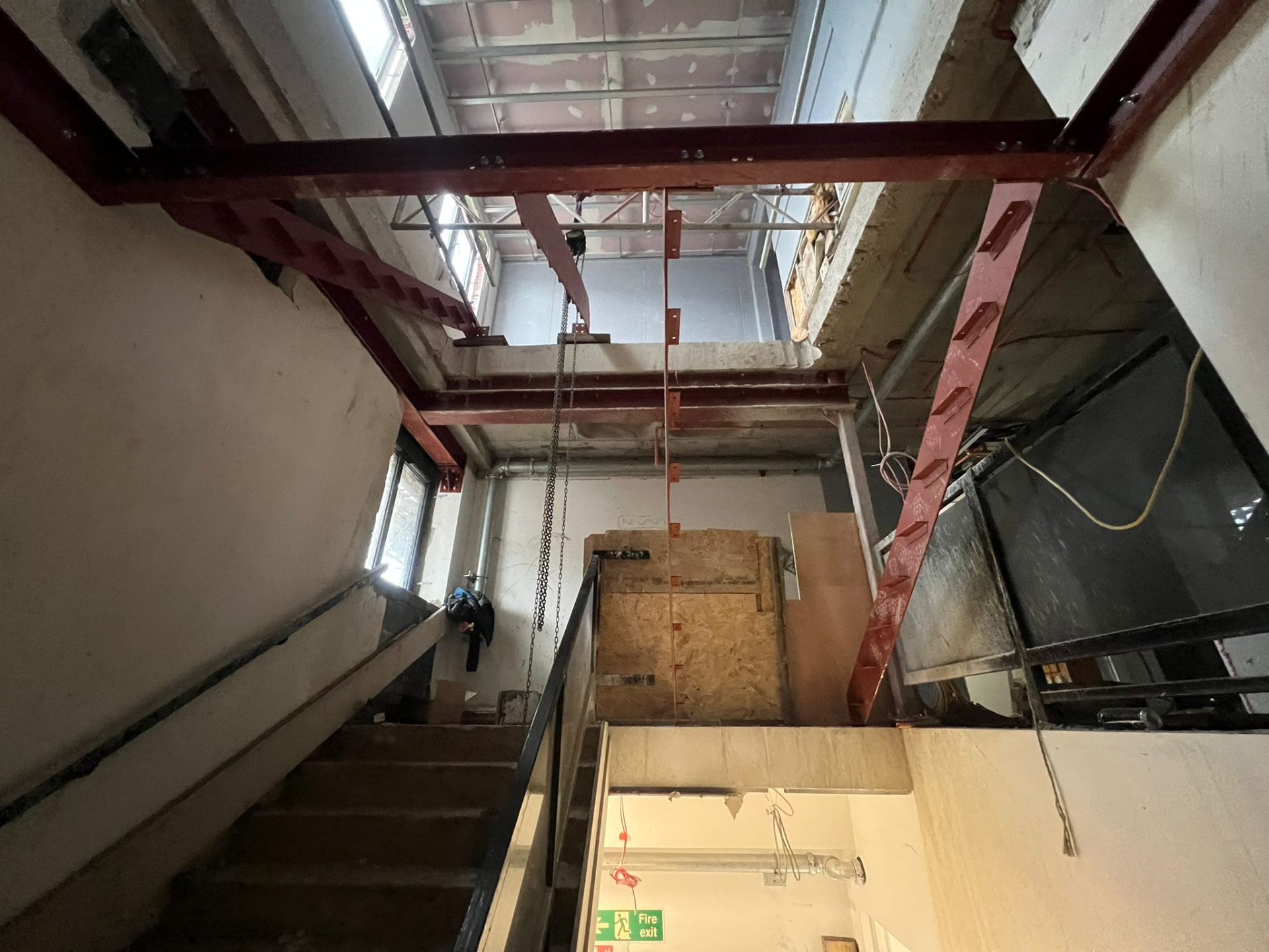 Structural steelwork frame supporting a multi-storey opening